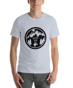 Unisex t-shirt with a black and white image of a dog pooping in front of a mountain range. It says "explore some shit" on it.