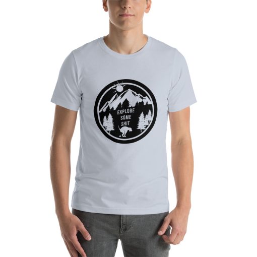 Unisex t-shirt with a black and white image of a dog pooping in front of a mountain range. It says "explore some shit" on it.